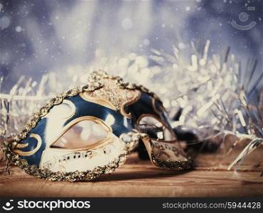 Christmas night, abstract holiday backgrounds with carnival mask over wooden desk