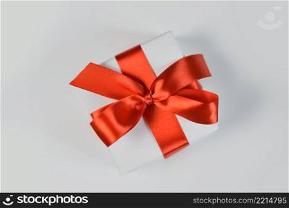 Christmas or any holidays mock up Gift box wrapped in paper and with red bow isolated on white background.. Christmas or any holidays mock up Gift box wrapped in paper and with red bow isolated on white background