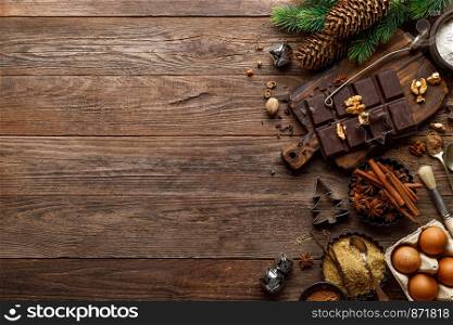 Christmas or new year culinary rustic wooden background with food ingredients for cooking festive dishes, xmas baking. Holiday cooking frame for Noel pastry on wooden table