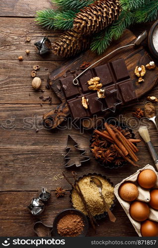 Christmas or new year culinary rustic wooden background with food ingredients for cooking festive dishes, xmas baking. Holiday cooking frame for Noel pastry on wooden table