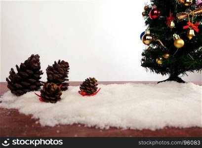 Christmas or New Year decoration background. gift pine cones and snow fir tree with copy space