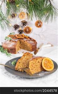 Christmas orange and spice cake. Decorated with dried oranges on kitchen countertop