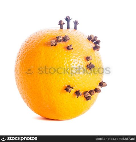 Christmas orange face made from cloves isolated on white