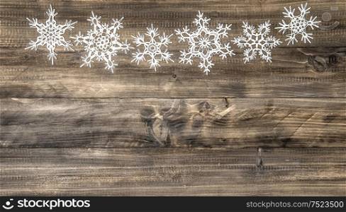 Christmas ornament white snowflakes on rustic wooden background