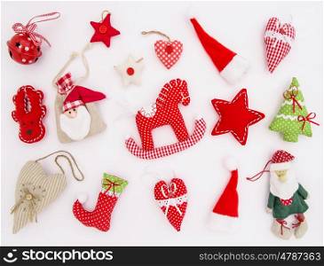 Christmas ornaments and decorations on white background. Red textile toys