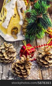 Christmas ornaments and pine cones on wooden background.