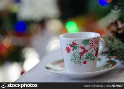 Christmas ornaments and turkish coffe cup on the table.Blurred background.