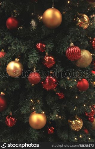 Christmas ornaments in red and gold on display in a Christmas shop