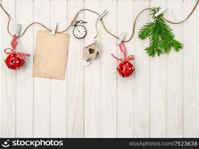 Christmas ornaments with greeting card. Christmas tree branches on bright wooden background