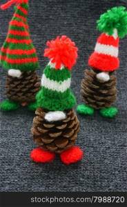Christmas pine gnome, pinecone wear Xmas hat for decoration on winter holiday, with red, green yarn, homemade product by knitted hat, food, nose make amazing and pretty gift