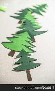 Christmas pine tree made of paper on paper background. Origami christmas tree