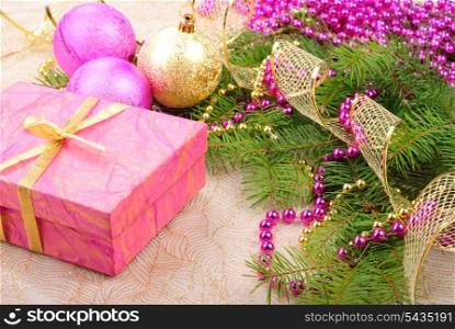 christmas pink and gold decorations on green pine branch