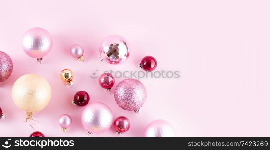 Christmas pink and golden decorations on pink background banner. Christmas decorations on pink