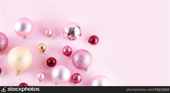 Christmas pink and golden decorations on pink background banner. Christmas decorations on pink