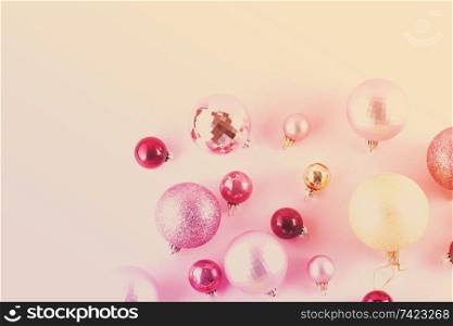 Christmas pink and golden decorations on pink background, toned. Christmas decorations on pink