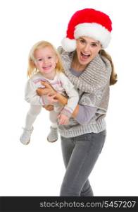 Christmas portrait of smiling mother playing with baby girl