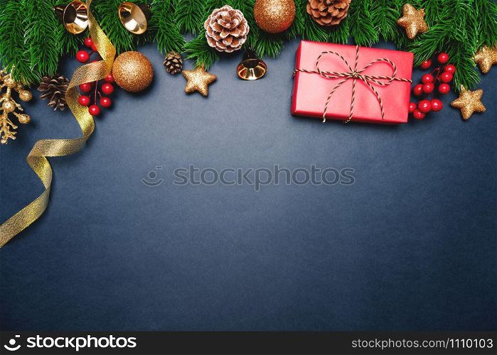 Christmas present and pine tree with xmas decoration on blue background