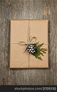 Christmas present in brown paper tied with string