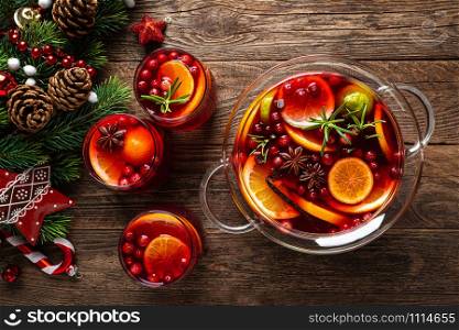 Christmas punch. Festive red cocktail, drink with cranberries and citrus fruits in a punch bowl and glasses
