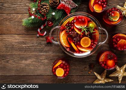 Christmas punch. Festive red cocktail, drink with cranberries and citrus fruits in a punch bowl and glasses