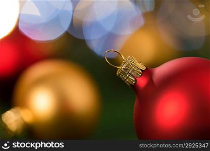 Christmas red and gold balls close-up shining lights background