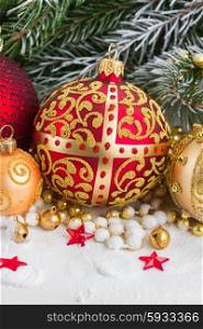christmas red and golden ball with evegreen tree in snow . christmas red and golden heart with evegreen tree