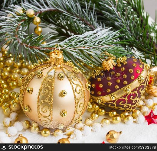 christmas red and golden heart with evegreen tree . christmas red heart and golden ball with evegreen tree in snow close up