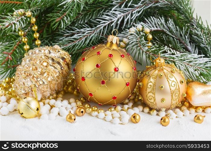 christmas red and golden heart with evegreen tree . pile of christmas golden balls with evegreen tree in snow