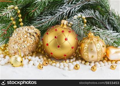 christmas red and golden heart with evegreen tree . pile of christmas golden balls with evegreen tree in snow