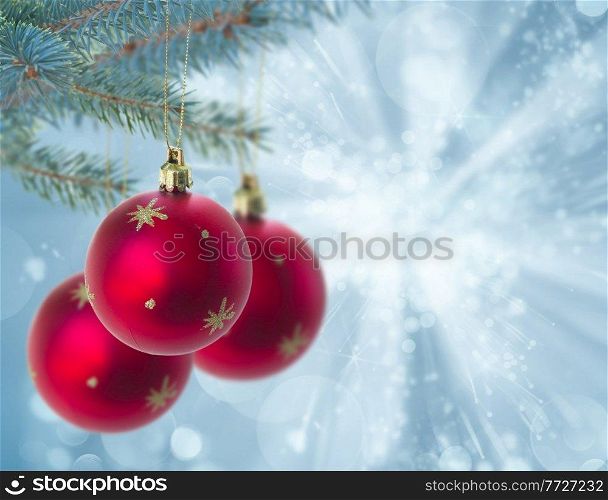 christmas red balls hanging on fir tree on blue bokeh, background. christmas red balls on blue background