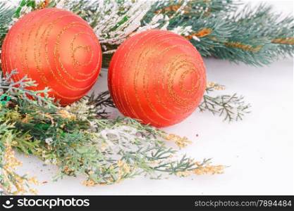 Christmas red balls with fir-tree branch on white background.