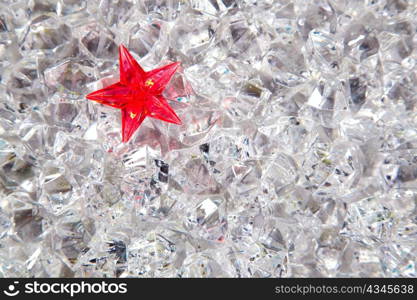 christmas red glass star on cold winter ice background