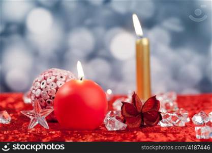 Christmas red golden candles on ice cubes with bokeh background