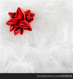 Christmas red ribbon look over white fur background