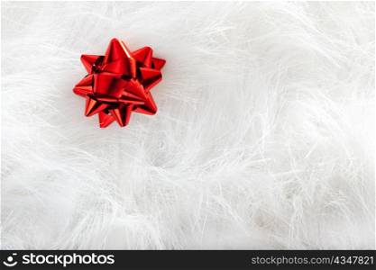 Christmas red ribbon look over white fur background