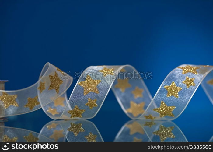 Christmas ribbon on mirror on blue background