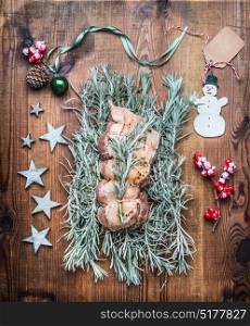 Christmas roast preparation on wooden background with festive decoration, top view