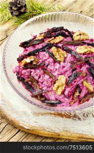Christmas salad with beets, prunes and nuts. Fresh beetroot salad with prunes