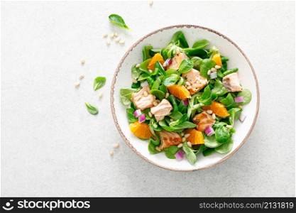 Christmas salmon orange salad with pine nuts, red onion and corn salad lettuce