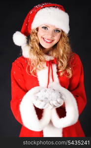 Christmas santa girl on black with heap of snow. Christmas greetings card