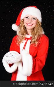 Christmas santa girl on black with heap of snow. Christmas greetings card