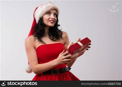 Christmas Santa hat woman portrait hold christmas gift. Smiling happy girl on white background.