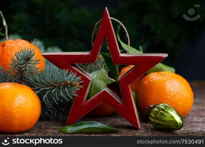 Christmas scene with fresh tangeines and red star. Christmas scene with tangerines