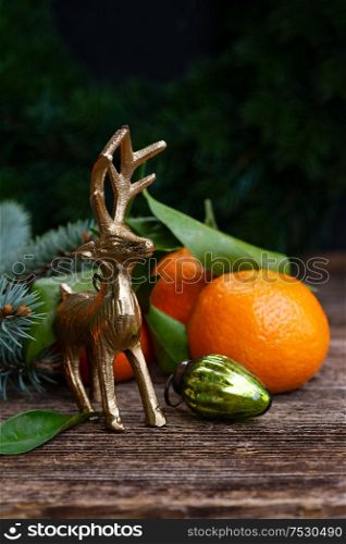 Christmas scene with fresh tangeines fruits and deer. Christmas scene with tangerines