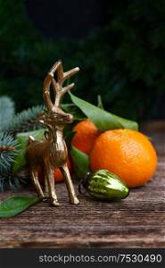 Christmas scene with fresh tangeines fruits and deer. Christmas scene with tangerines
