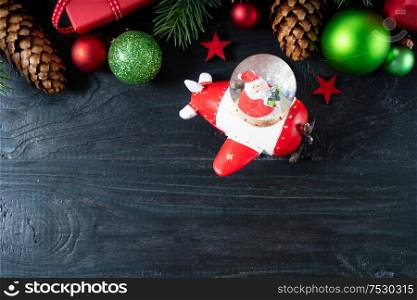 Christmas scene with Santa Claus and decorations, Christmas celebration and gift giving concept over black. Christmas flat lay scene with golden decorations