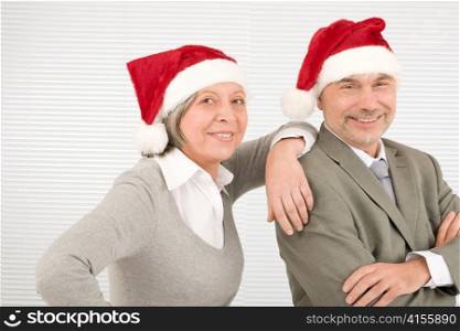 Christmas senior businesspeople having fun with Xmas hat