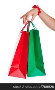 Christmas shopper with red and green shopping bags. Shot on white background.