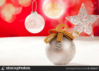 Christmas silver bauble and star on snow red background