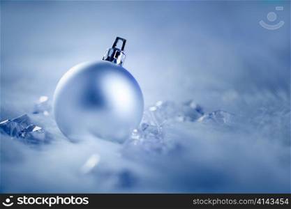 christmas silver bauble on fur snow and ice cold winter